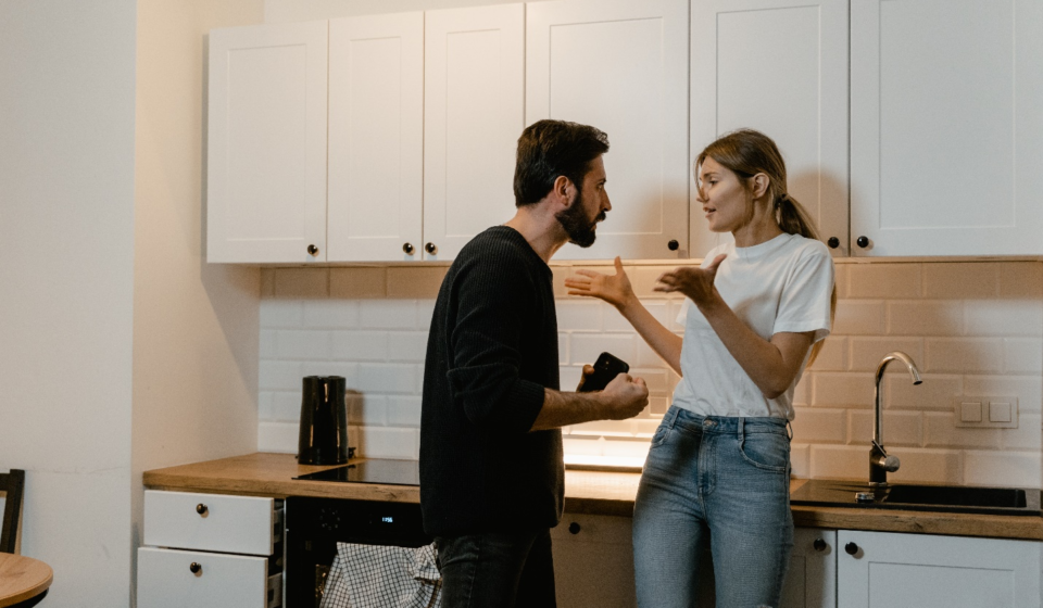man and woman arguing in a kitchen